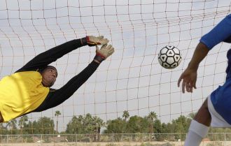 Striker scores into the net