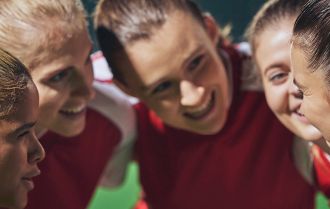 Girls learn from the coach