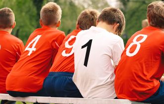 Subs on the bench at a soccer match
