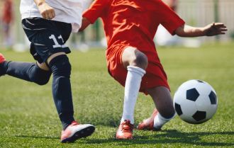 Competition between defender and forward soccer players