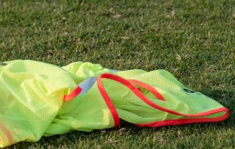 Stretching warm up involving passing bibs